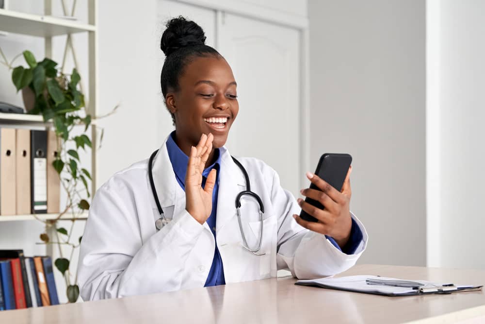 Doctor chats with a patient on a video call using a HIPAA-compliant mobile app