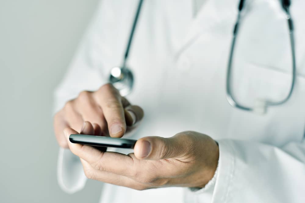 Doctor uses HIPAA-compliant mobile app on their phone