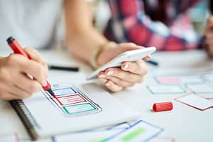 Coworkers strategize marketing with mobile app ideas